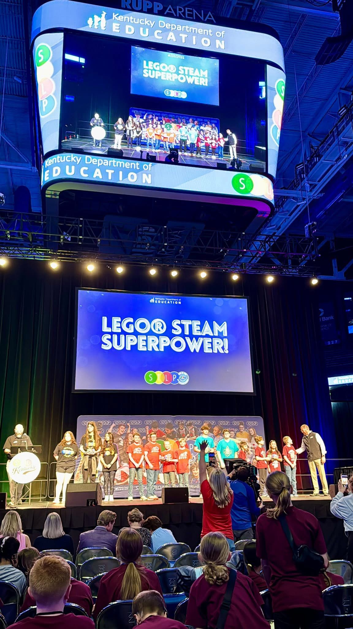 Presetners on stage in Rupp Arena for STLP State Championship awards show